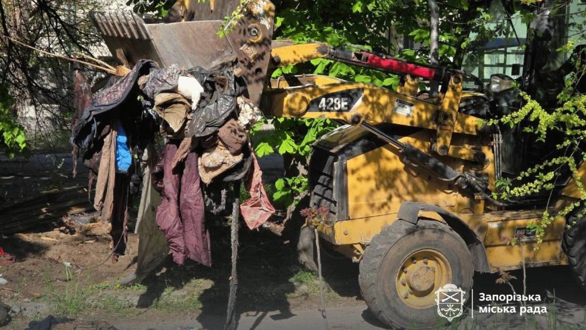 У Запоріжжі безпритульна залишила гори сміття біля багатоповерхівки: територію довелося розчищати технікою